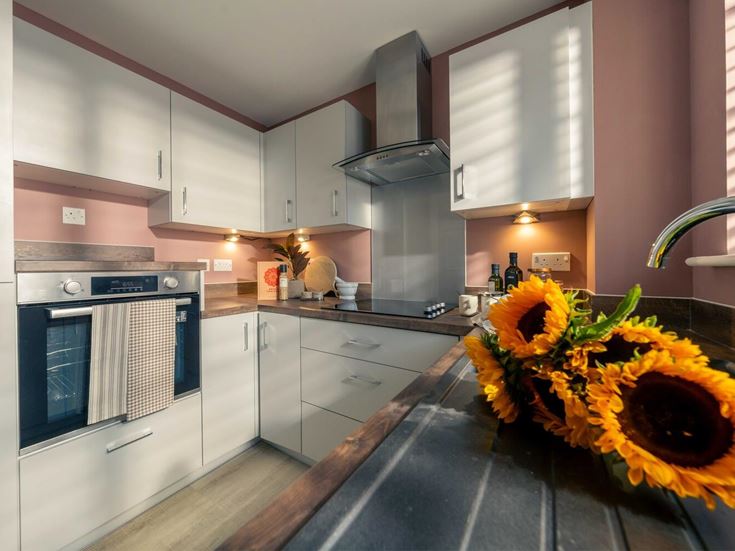 a kitchen with a large flower in the middle