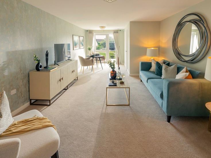 a living room with a couch and a mirror