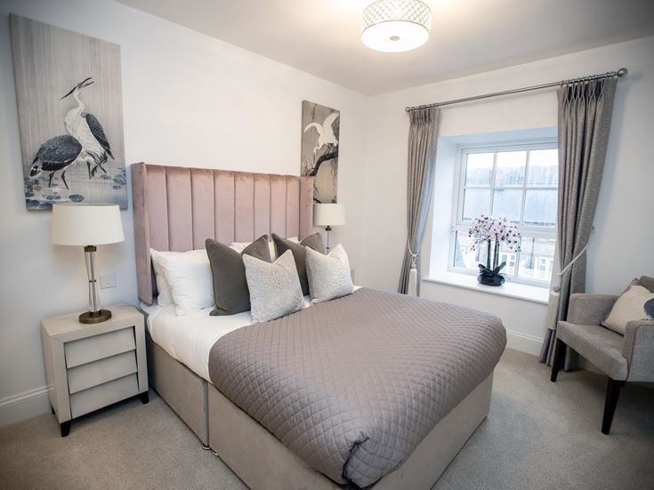 a bedroom with a bed and a chair