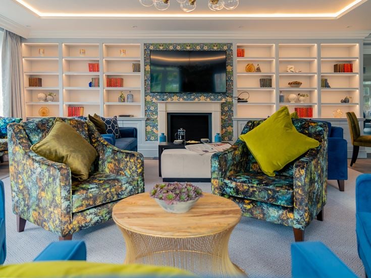 a living room with blue chairs