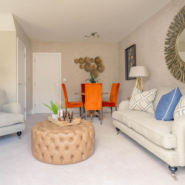 a living room with a white couch and a round table