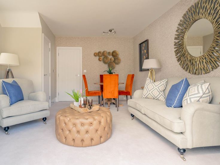 a living room with a white couch and a round table