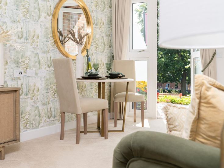 a room with a table chairs and a mirror