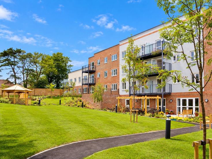 a building with a lawn and trees