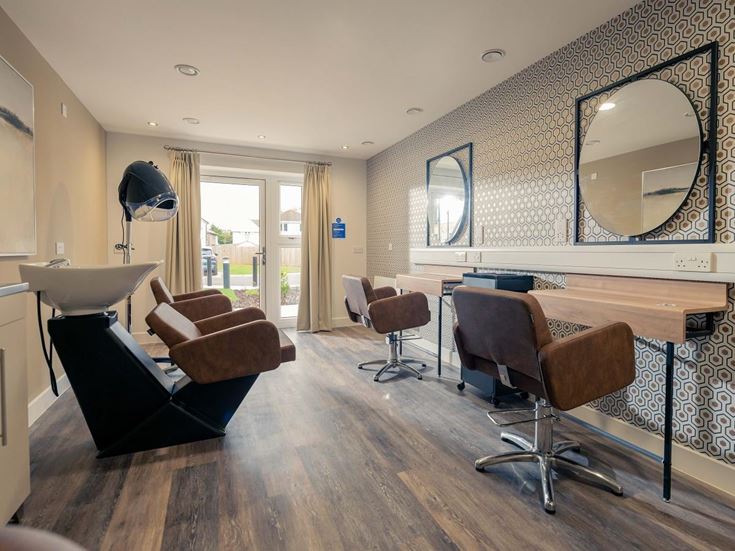 a room with a bar and chairs