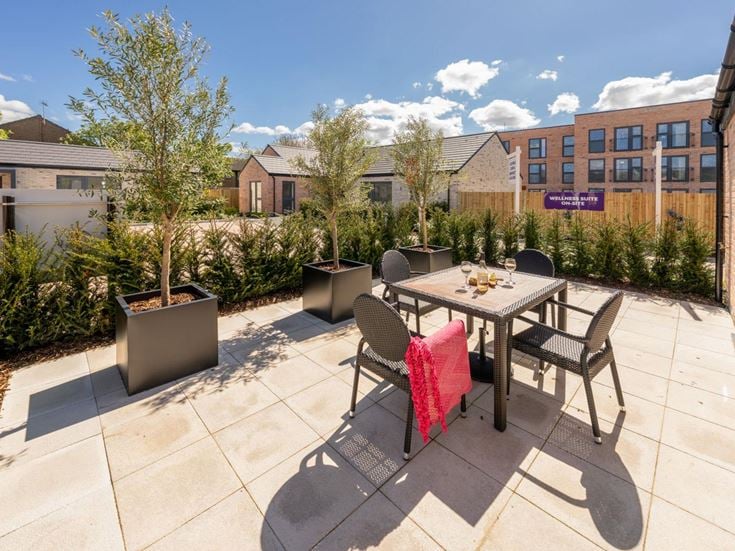 a patio with a table and chairs