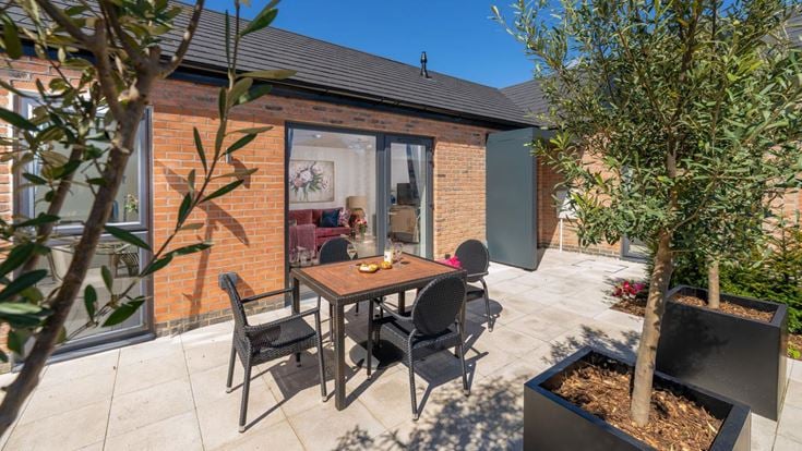 a table and chairs outside a house
