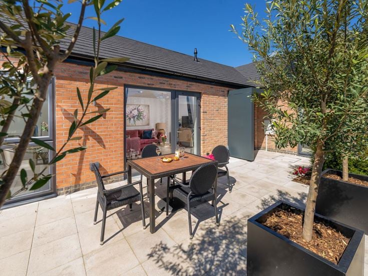 a table and chairs outside a house