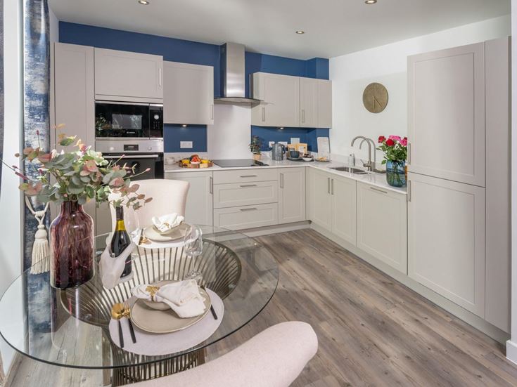a kitchen with a table and chairs