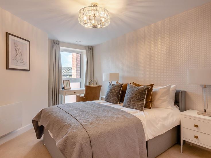 a bedroom with a bed and lamps