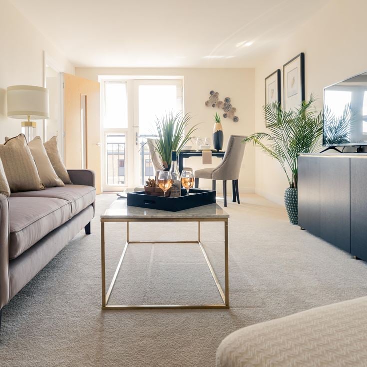 a living room with a table and couches