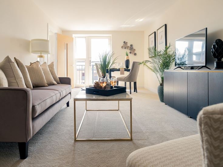 a living room with a table and couches