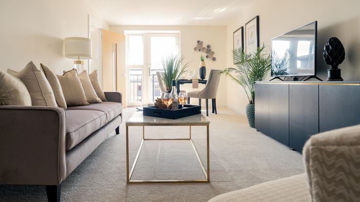 a living room with a table and couches