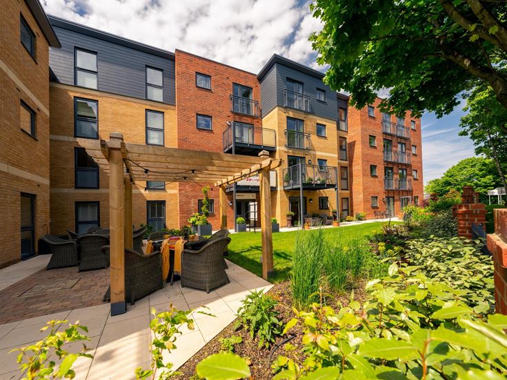 a courtyard with a building in the background