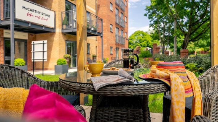 a table outside with chairs and a basket on it