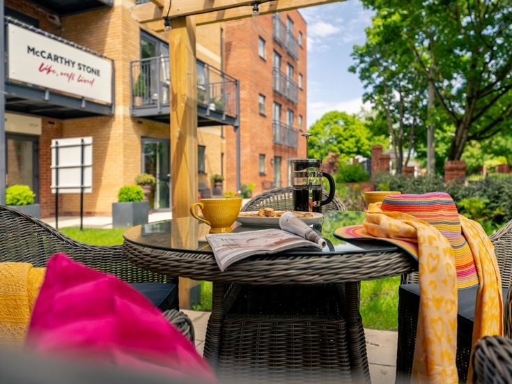 a table outside with chairs and a basket on it