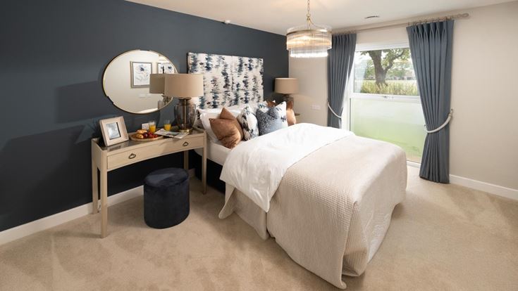 a bedroom with a bed and a desk