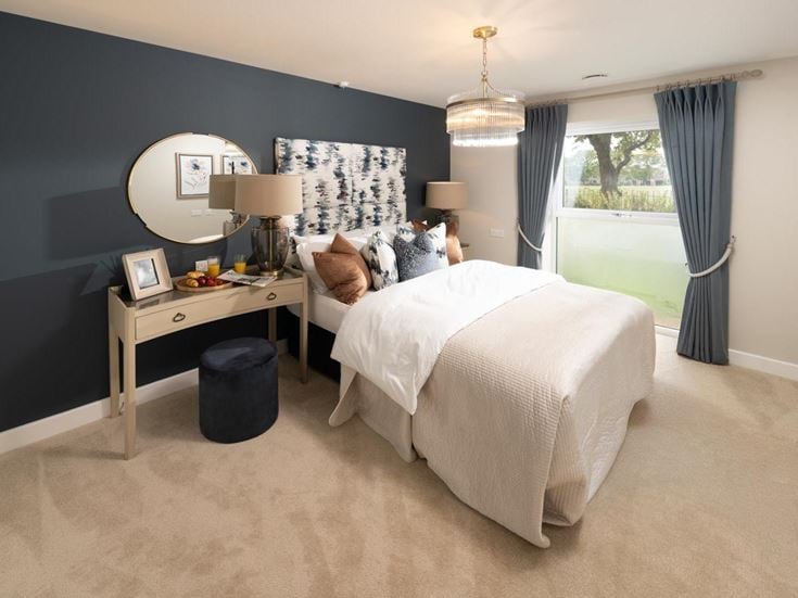 a bedroom with a bed and a desk