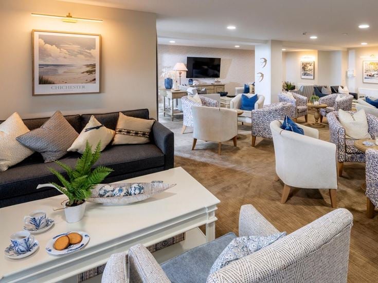a living room with a couch and chairs