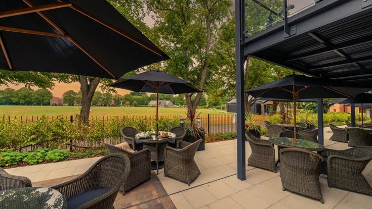 a patio with chairs and umbrellas