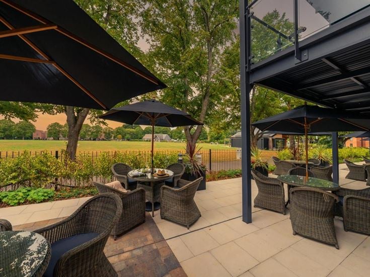 a patio with chairs and umbrellas