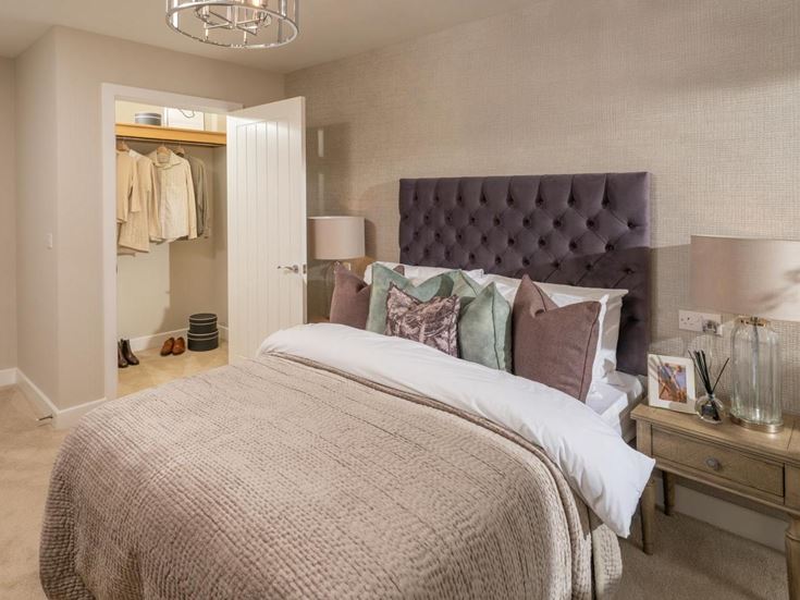 a bedroom with a bed and a lamp