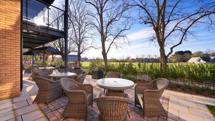 a patio with tables and chairs