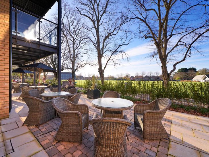 a patio with tables and chairs