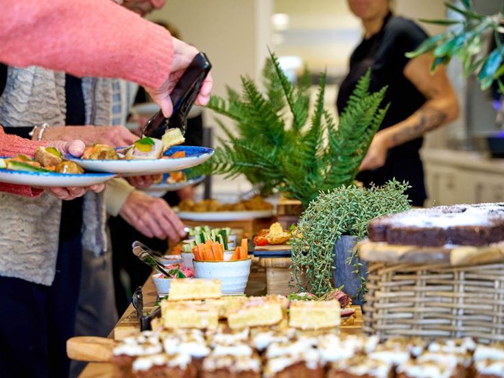 a woman cutting a cake