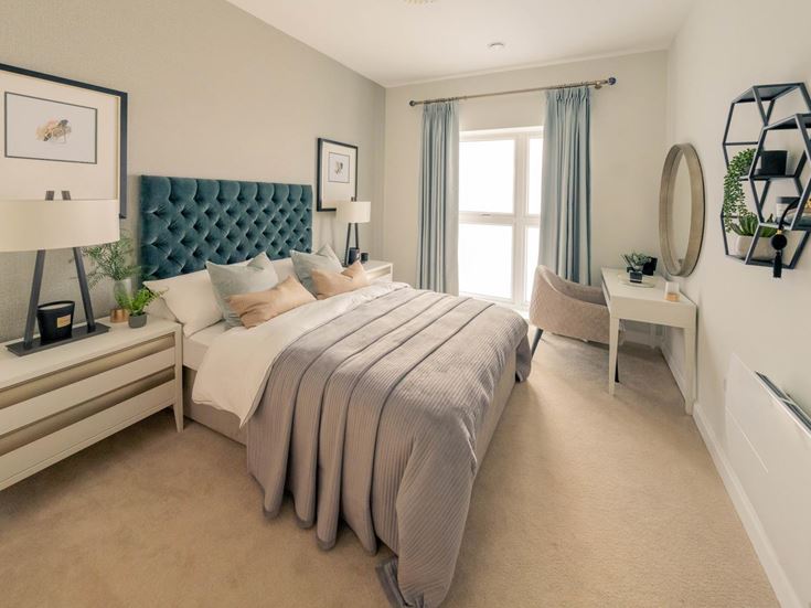 a bedroom with a bed and a chair