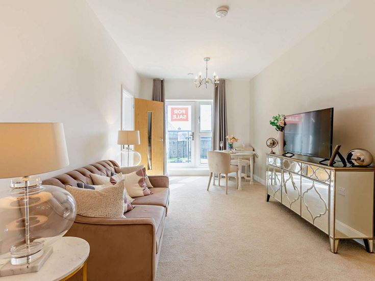 a living room with a tv and couches