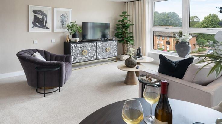 a living room with a couch and wine bottle
