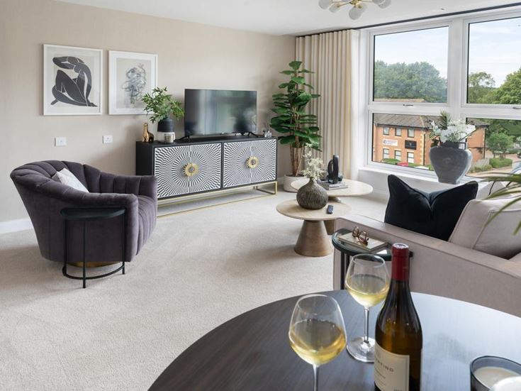 a living room with a couch and wine bottle