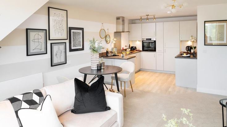 a living room with white furniture