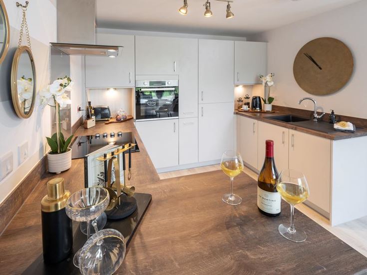 a kitchen with wine glasses and bottles