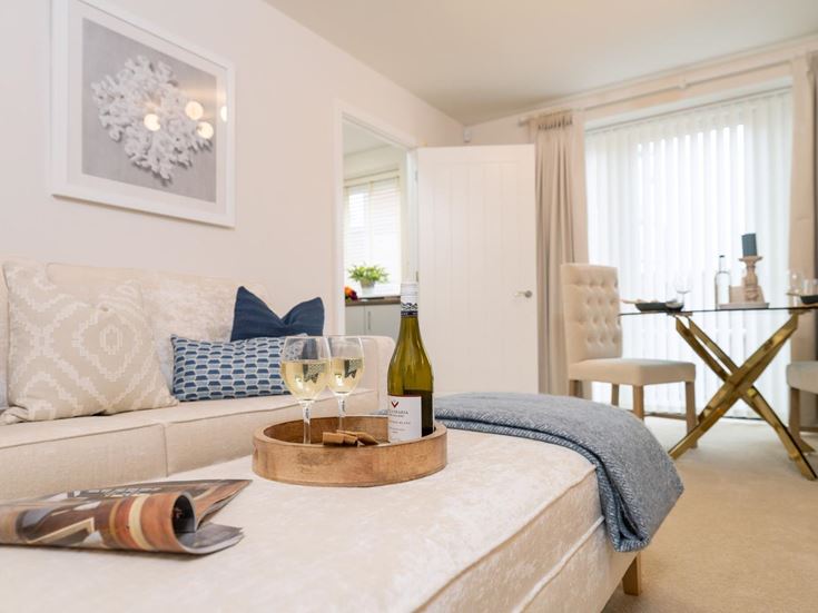 a living room with a couch and wine bottle