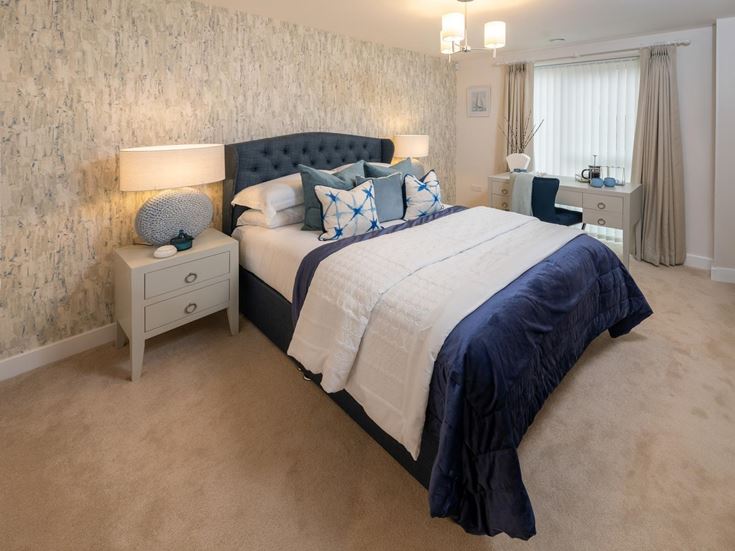 a bed with a blue comforter
