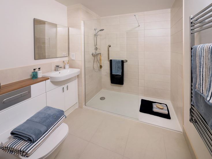 a bathroom with a tub sink and towels