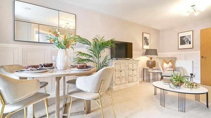 a living room with a table and chairs