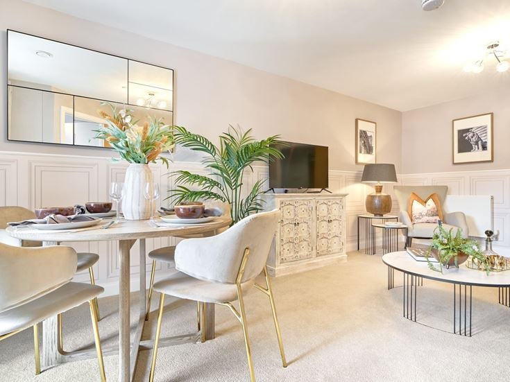 a living room with a table and chairs