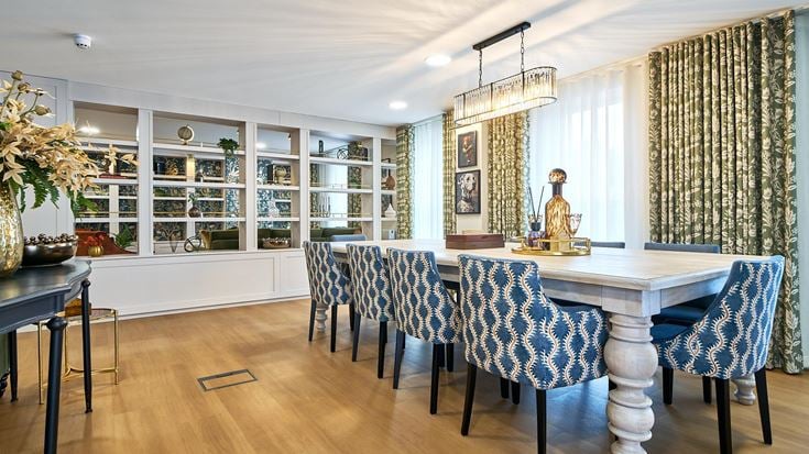 a dining room with a table and chairs