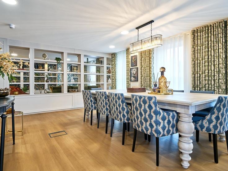a dining room with a table and chairs