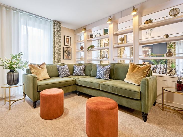 a living room with a green couch