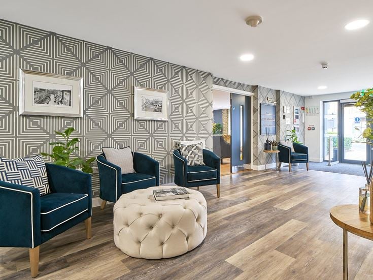 a room with a couch and chairs