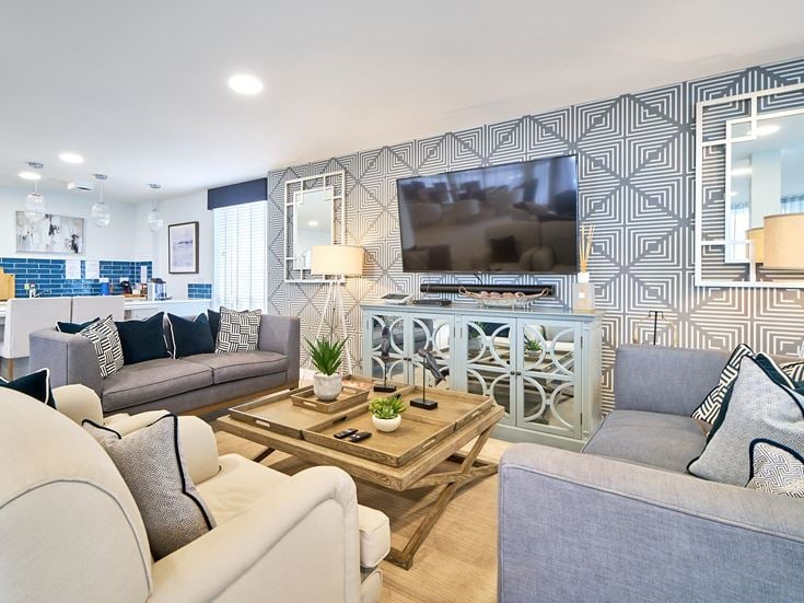 a living room with a tv and couches