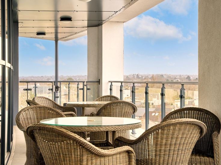 a patio with a table and chairs