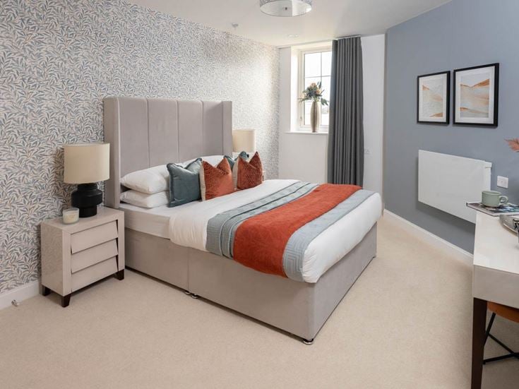 a bedroom with a bed and a desk