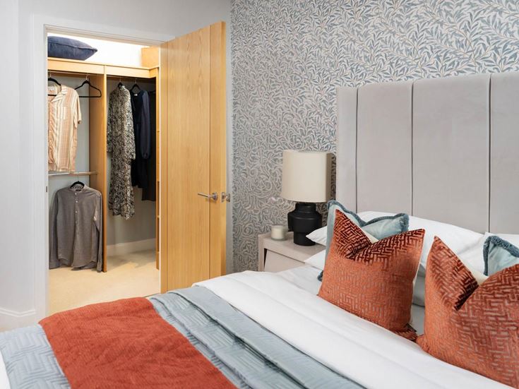 a bedroom with a bed and a lamp