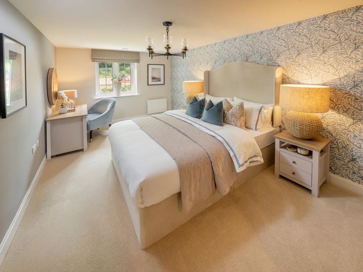 a bedroom with a bed and a chair