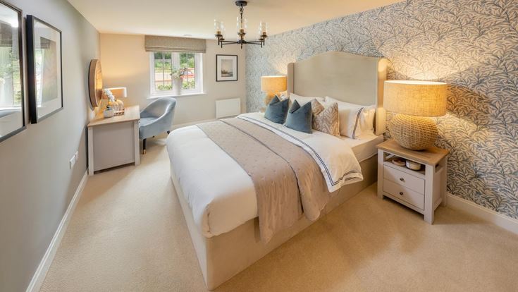 a bedroom with a bed and a chair